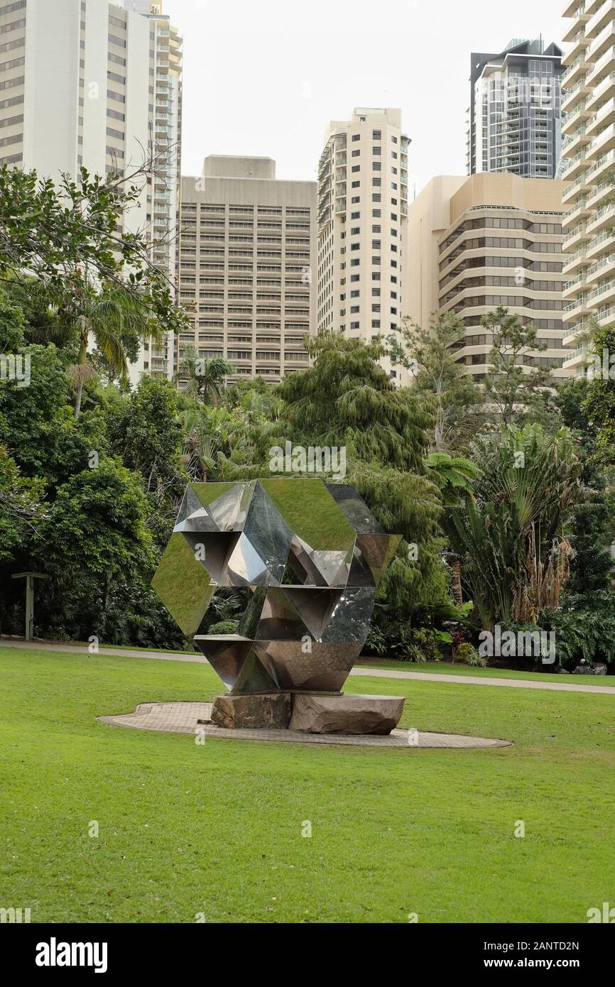 Morning Star, mirror finish metal sculpture, City Botanic Gardens, Gardens Point, by Jon Barlow Hudson with hi-rise of Brisbane city in the background Stock Photo