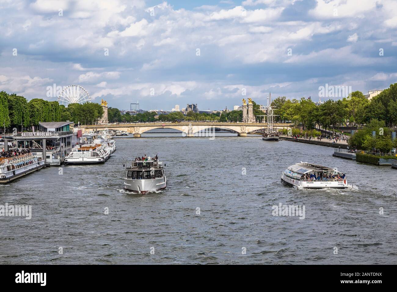 PARIS, FRANCE - MAY 15, 2016: Seine river with pleasure boats on the background of the bridge Alexander 3, and Louvre. Paris. France Stock Photo
