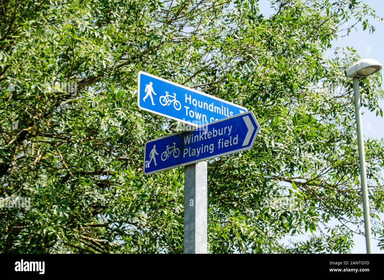 Fingerpost direction signs for pedestrians and cyclists in Basingstoke, Hampshire. Sunny summer day. Stock Photo