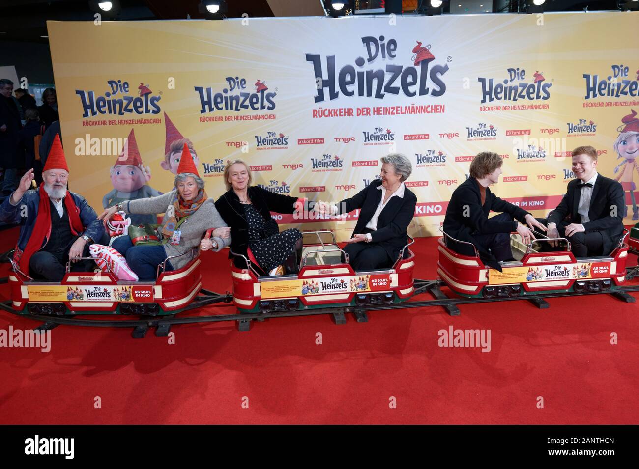 Cologne, Germany. 19th Jan, 2020. The actors Bill Mockridge Margie Kinsky, Elke Heidenreich, Marie-Luise Marjan, Louis Hofmann and Leon Seidel (l-r) sit in a children's train before the premiere of the film 'The Heinzels - Return of the Brown Men'. The animated film will start in the cinemas on 30.01.2020. Credit: Henning Kaiser/dpa/Alamy Live News Stock Photo