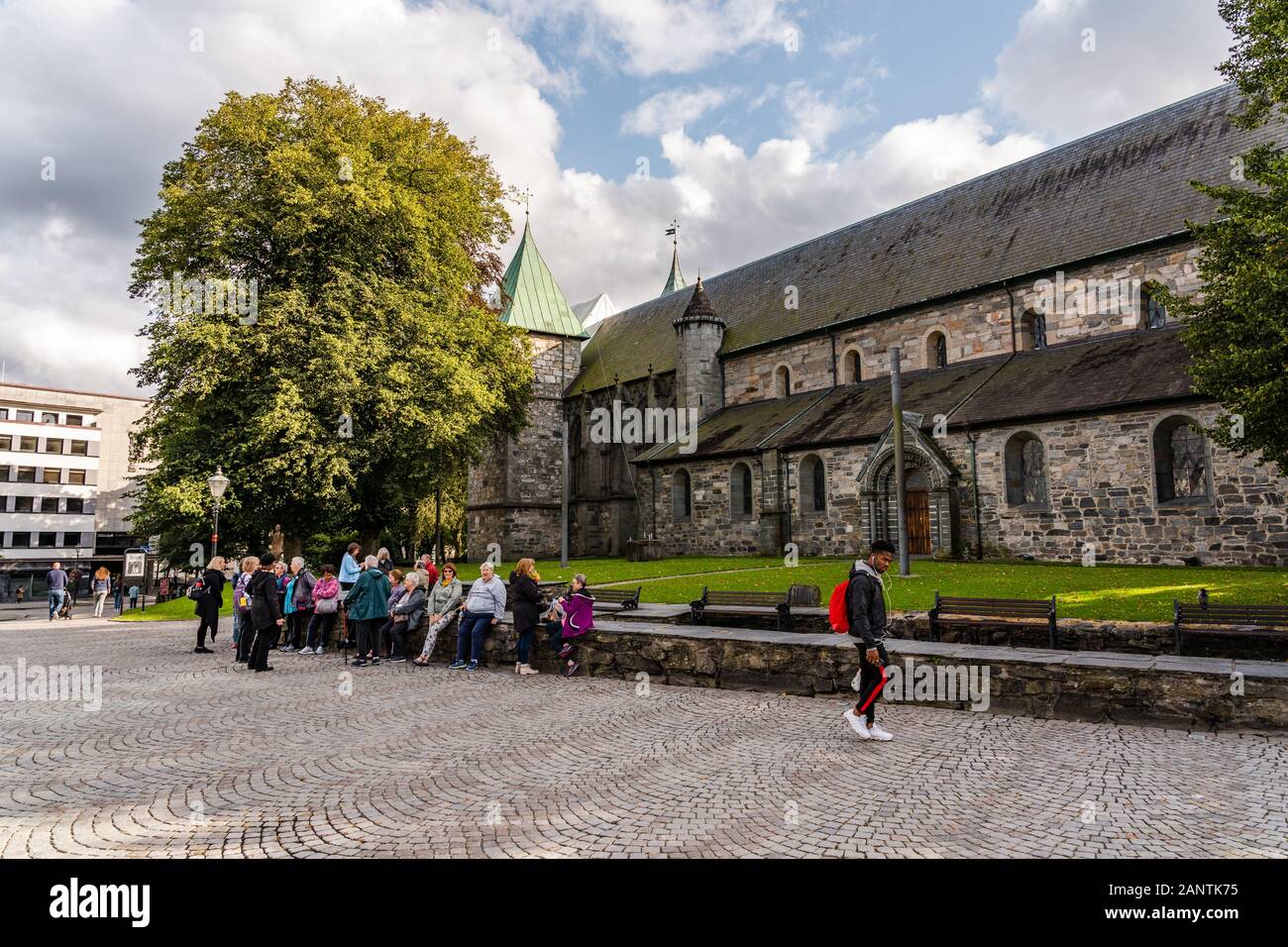 Editorial 09.02.2019 Stavanger Norway The old Cathedral of the city with people sitting outside at Domkirkeplassen Stock Photo