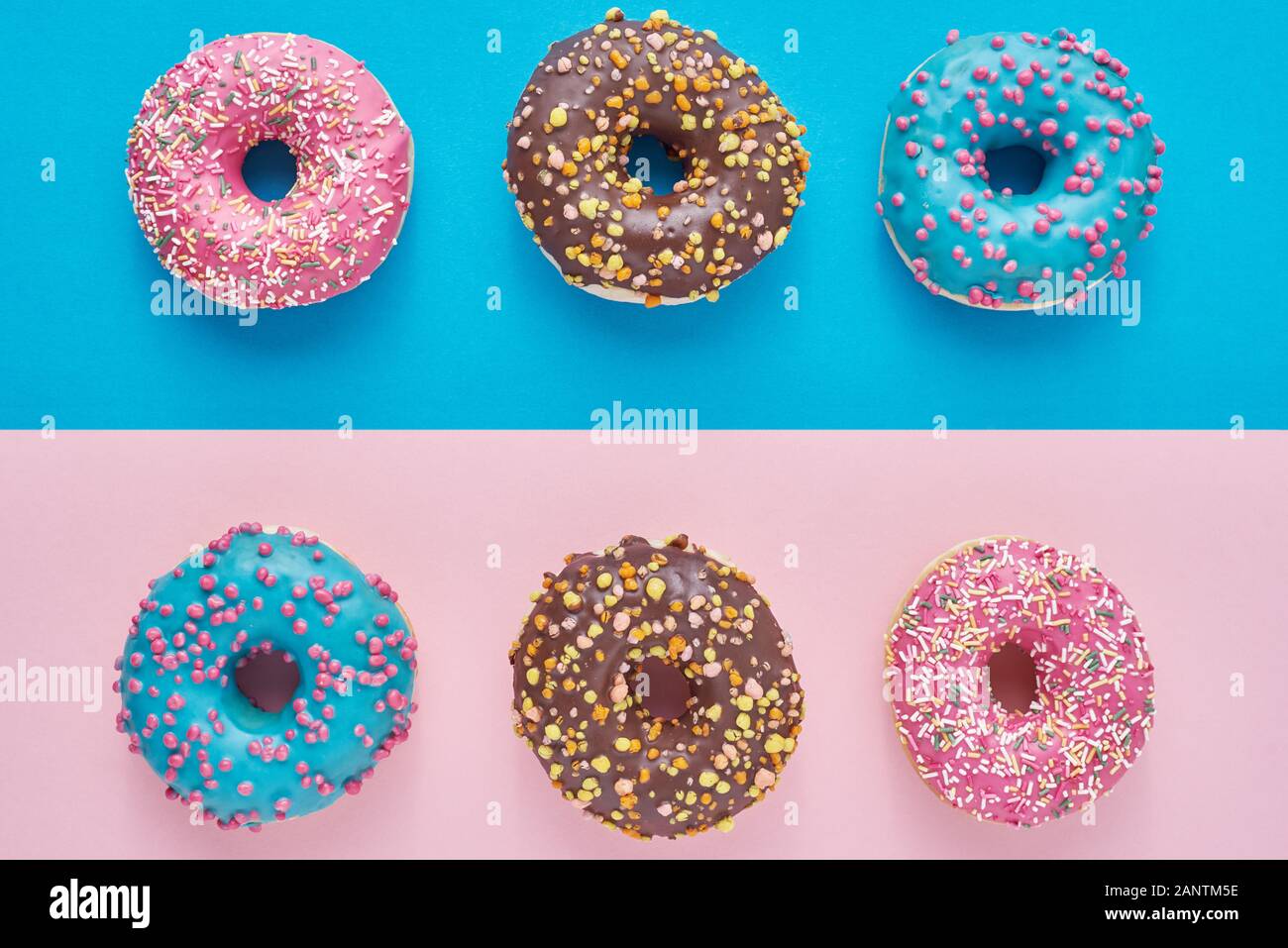 Donuts on pastel pink and blue background. Minimalism creative food