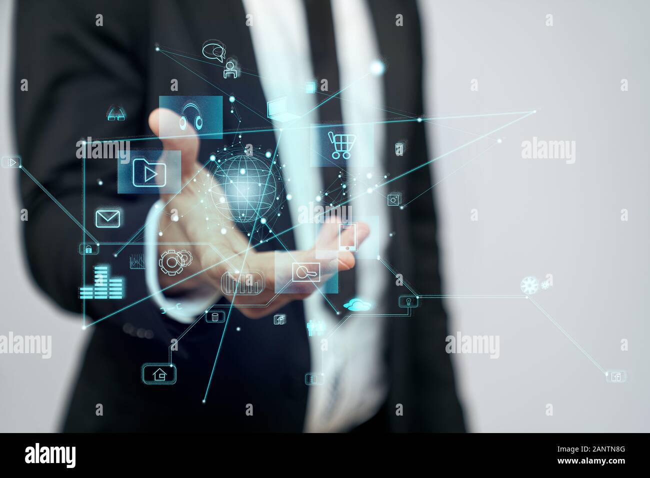 Close up of incognito businessman in suit standing in office. Selective focus of virtual projection of digital tactile charts screen, man holding in hand. Concept of high technologies, digitalization. Stock Photo