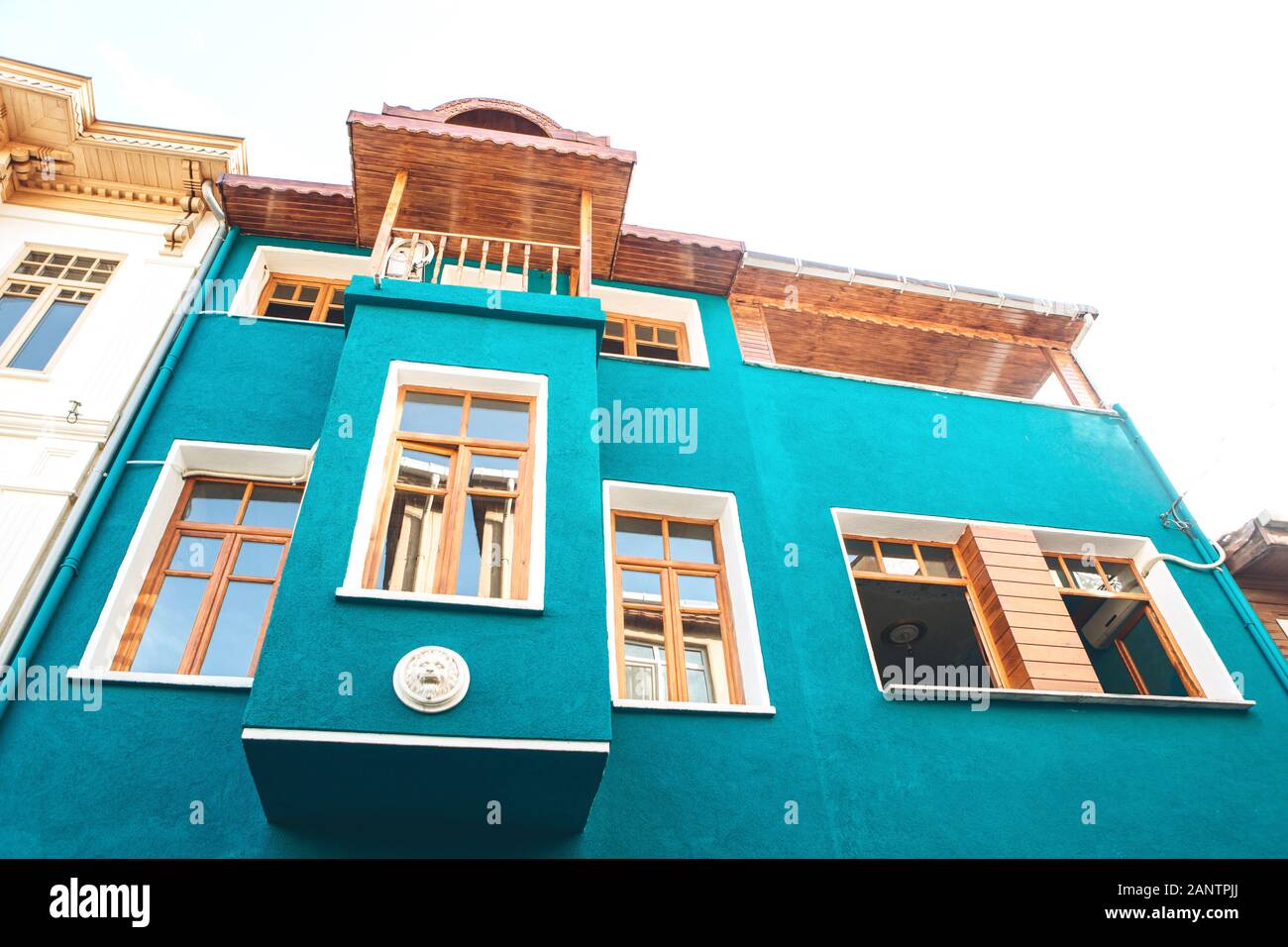 A turquoise-colored old traditional residential building in the Balat district of Istanbul in Turkey. The houses in this area were built in the 15-18 centuries, not later. Stock Photo