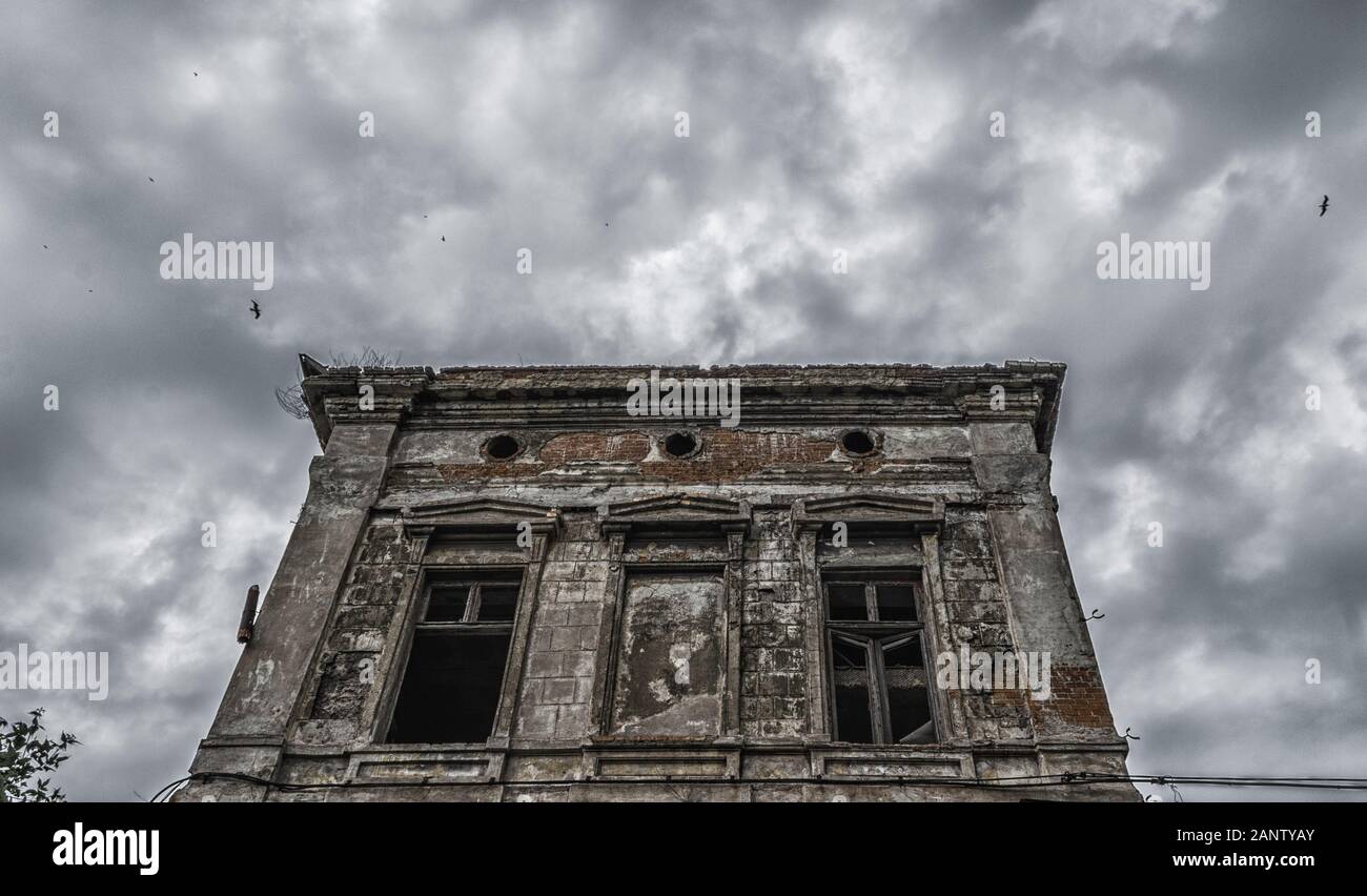 destroyed old building on a gloomy cloudy sky with birds Stock Photo ...