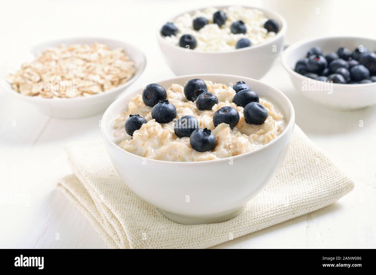 Oatmeal porridge with blueberries in bowl. Healthy breakfast Stock Photo