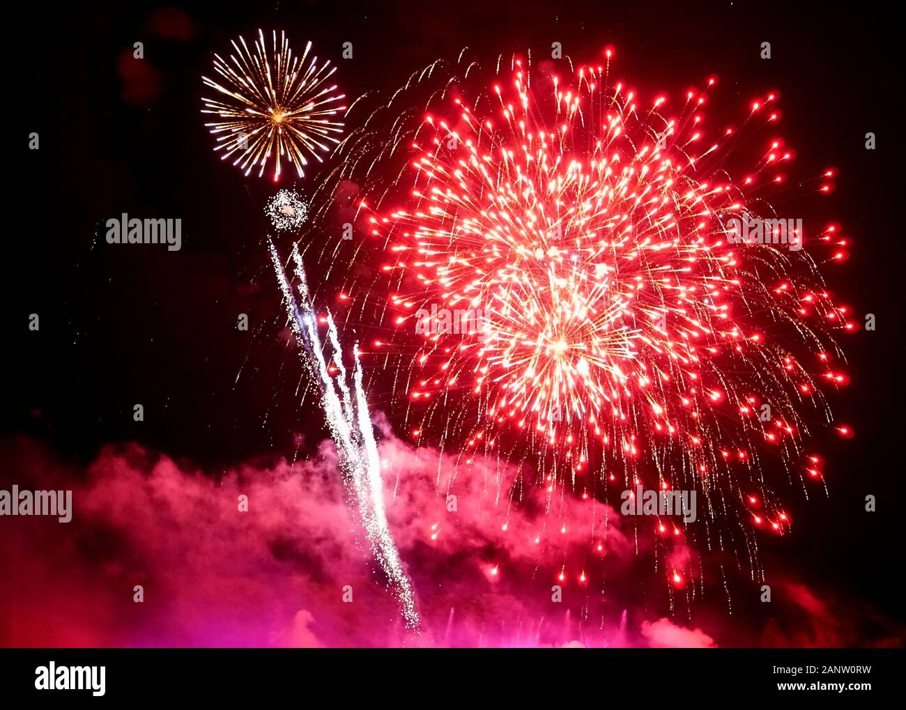 Stunning red fireworks balls exploding on the sky at night Stock Photo ...