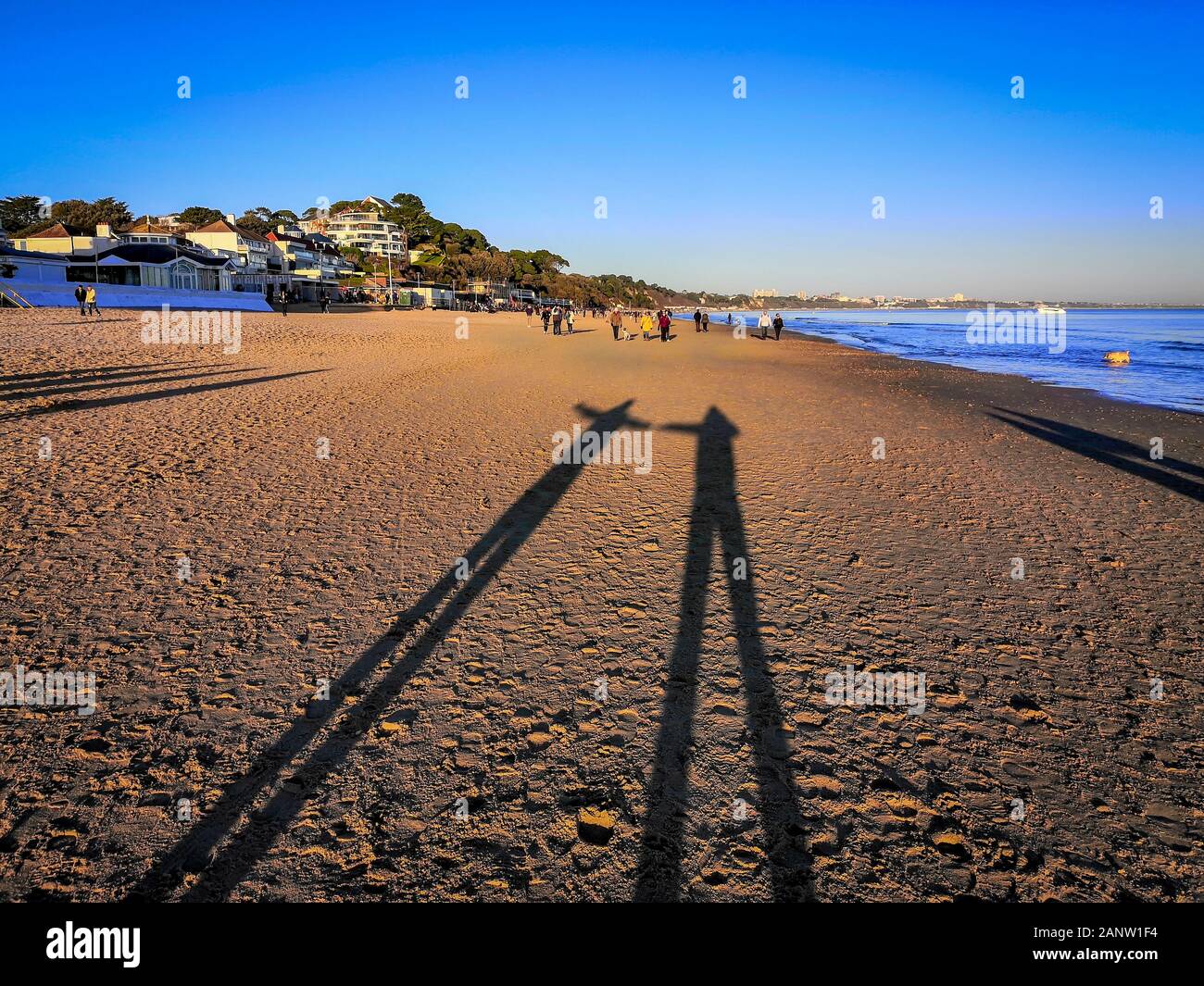 Bournemouth, UK. Sunday 19th January 2020. Low winter sun casts very long shadows on Bournemouth beach on a clear sunny day. Credit: Thomas Faull/Alamy Live News Stock Photo