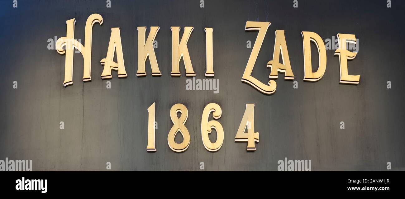 Hakki Zade was established in 1864 as a confectioner. Hakki Zade sign photographed nearby. Gold color on black surface. Stock Photo