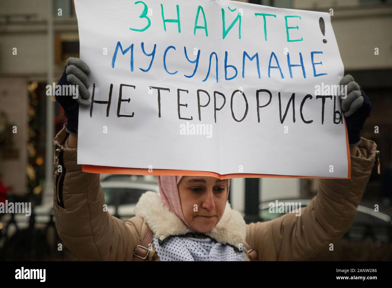 Moscow, Russia. 19th of January, 2020 Muslim woman holds banner reading 'Know! Muslims are not terrorists' in a march in memory of lawyer Stanislav Markelov and journalist Anastasia Baburova in Tverskoy Boulevard in central Moscow, Russia Stock Photo