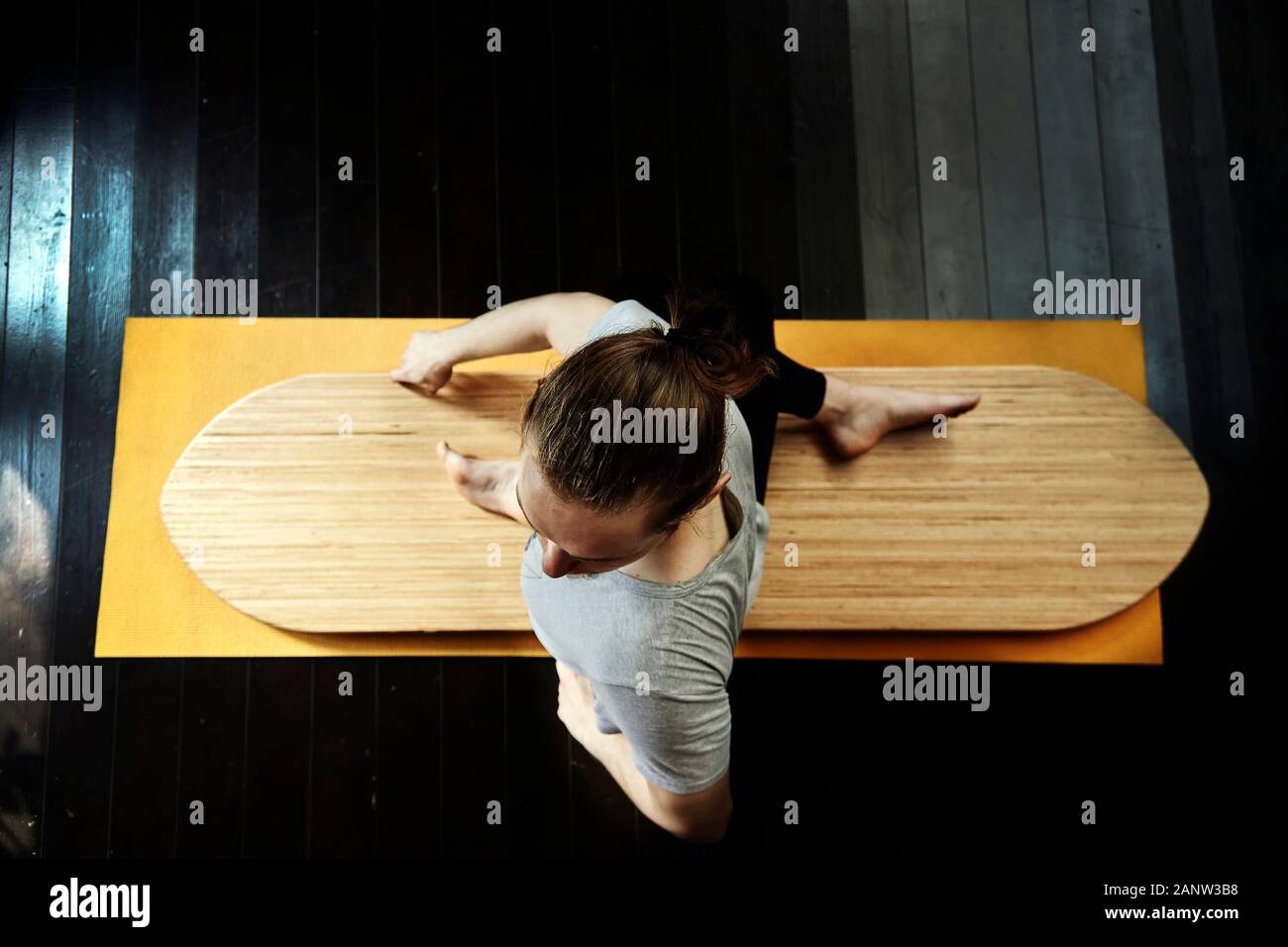 young man practicing yoga on a yoga board. Stock Photo
