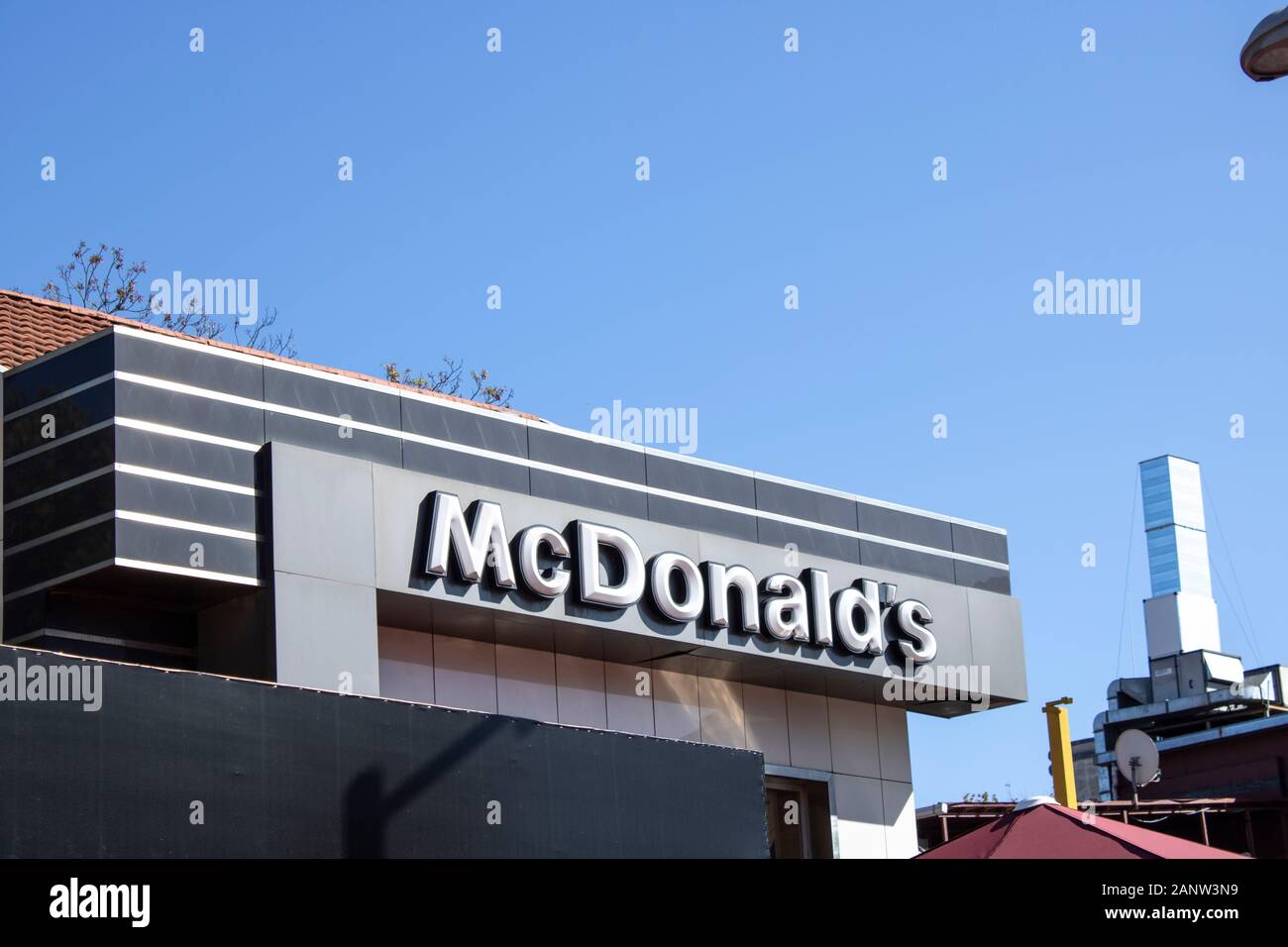 McDonald's restaurant sign. The McDonald's Corporation is the world's largest chain of hamburger fast food restaurants. Stock Photo