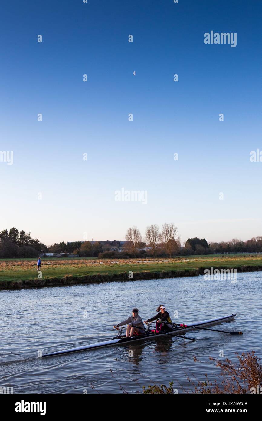 Early morning double scull training on the River Cam, Cambridge. A clear sky shows a faint moon. Stock Photo