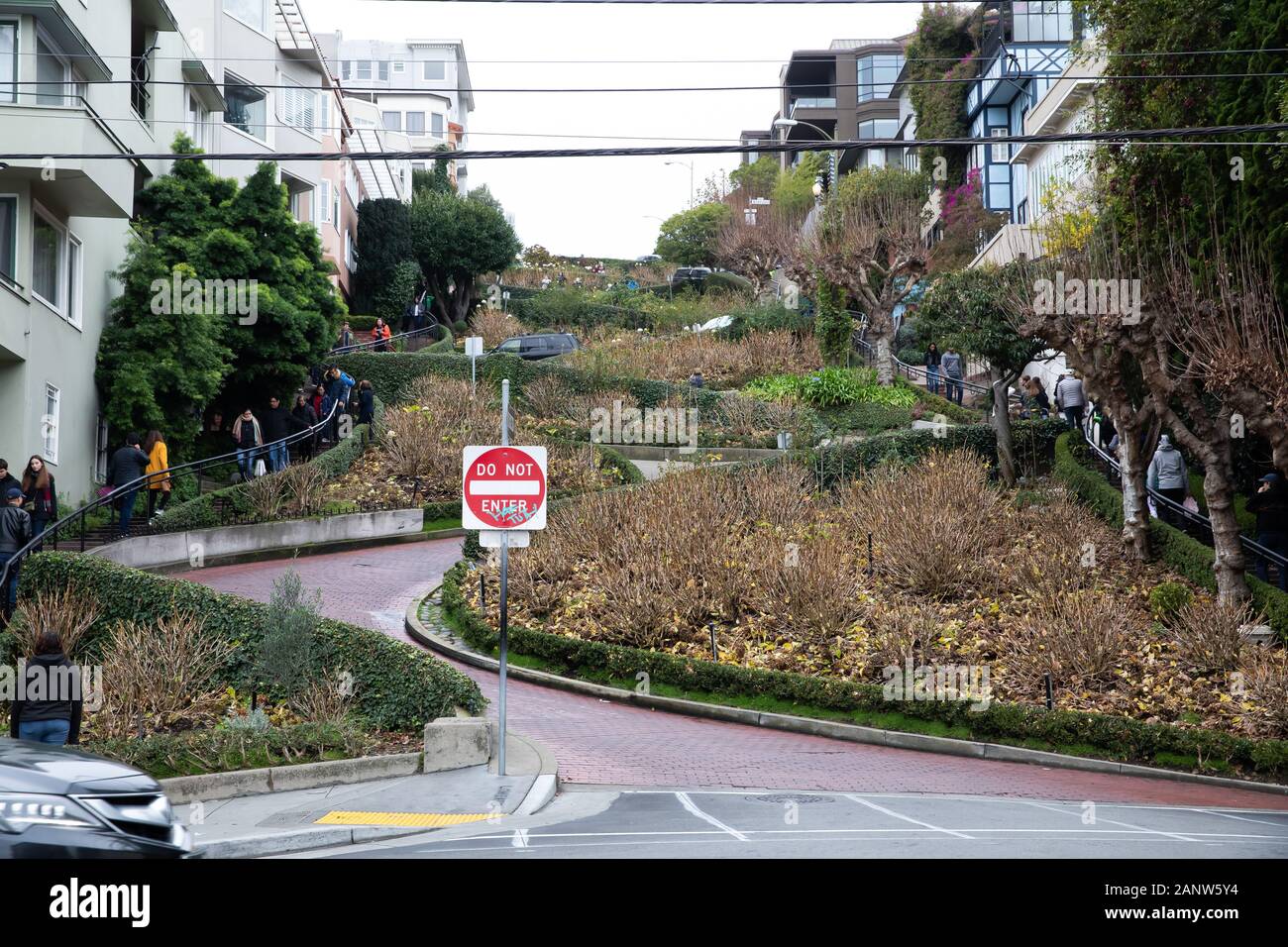 Cars drive slowly down Lombard Street, known as the crookedest street