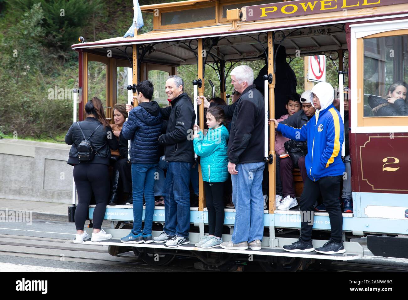 Crowded Cable Car passes the famous Lombard Street in San Francisco