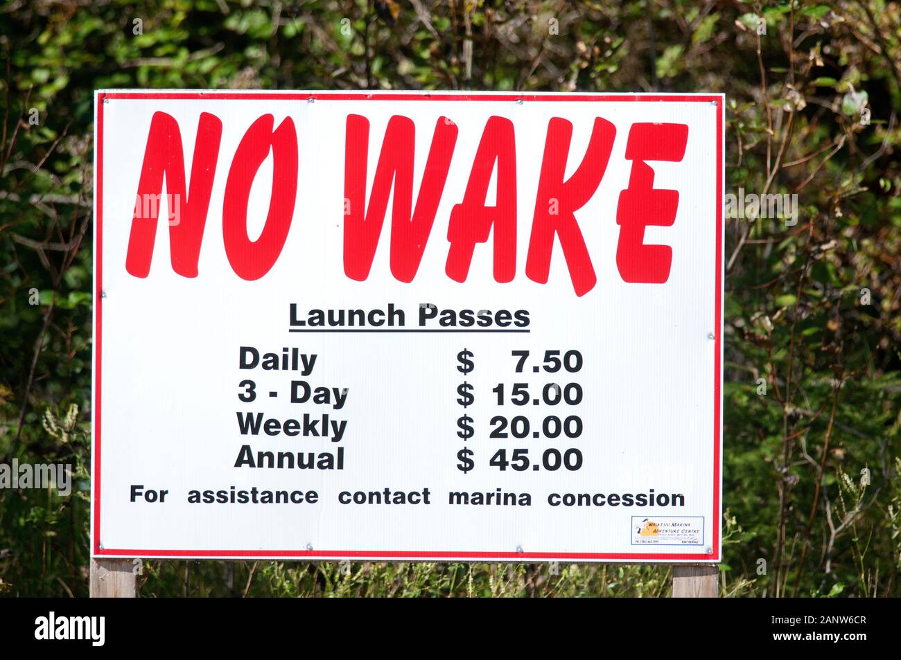 No wake sign and launch passes fares on the shore of Waskesiu lake, Prince Albert National Park, Saskatchewan, Canada Stock Photo