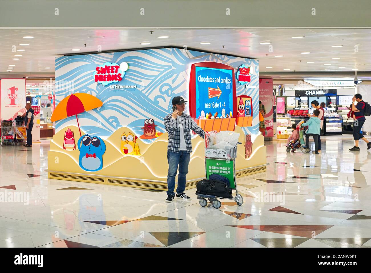 Hong Kong Young man makes phone call at the duty free shops area