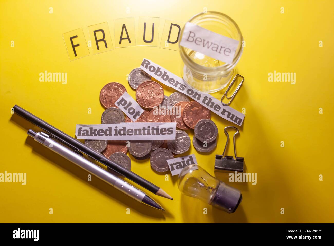 Flat lay still life on concept of fraud & scams. Yellow background. Copyspace. Stock Photo