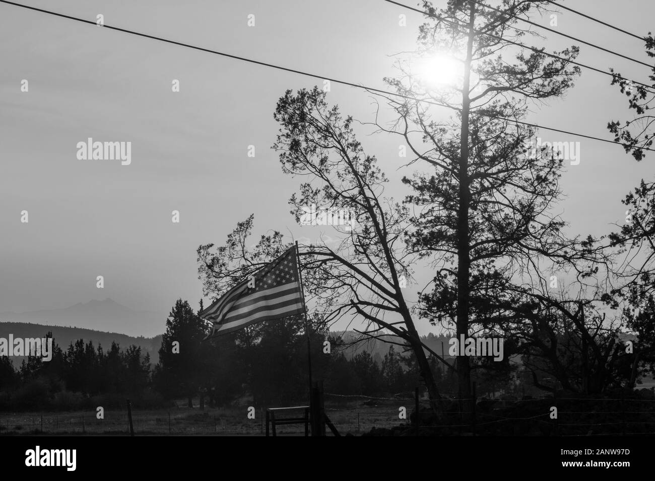 Sunset light passes through a waving U.S. flag near Terrebonne Stock