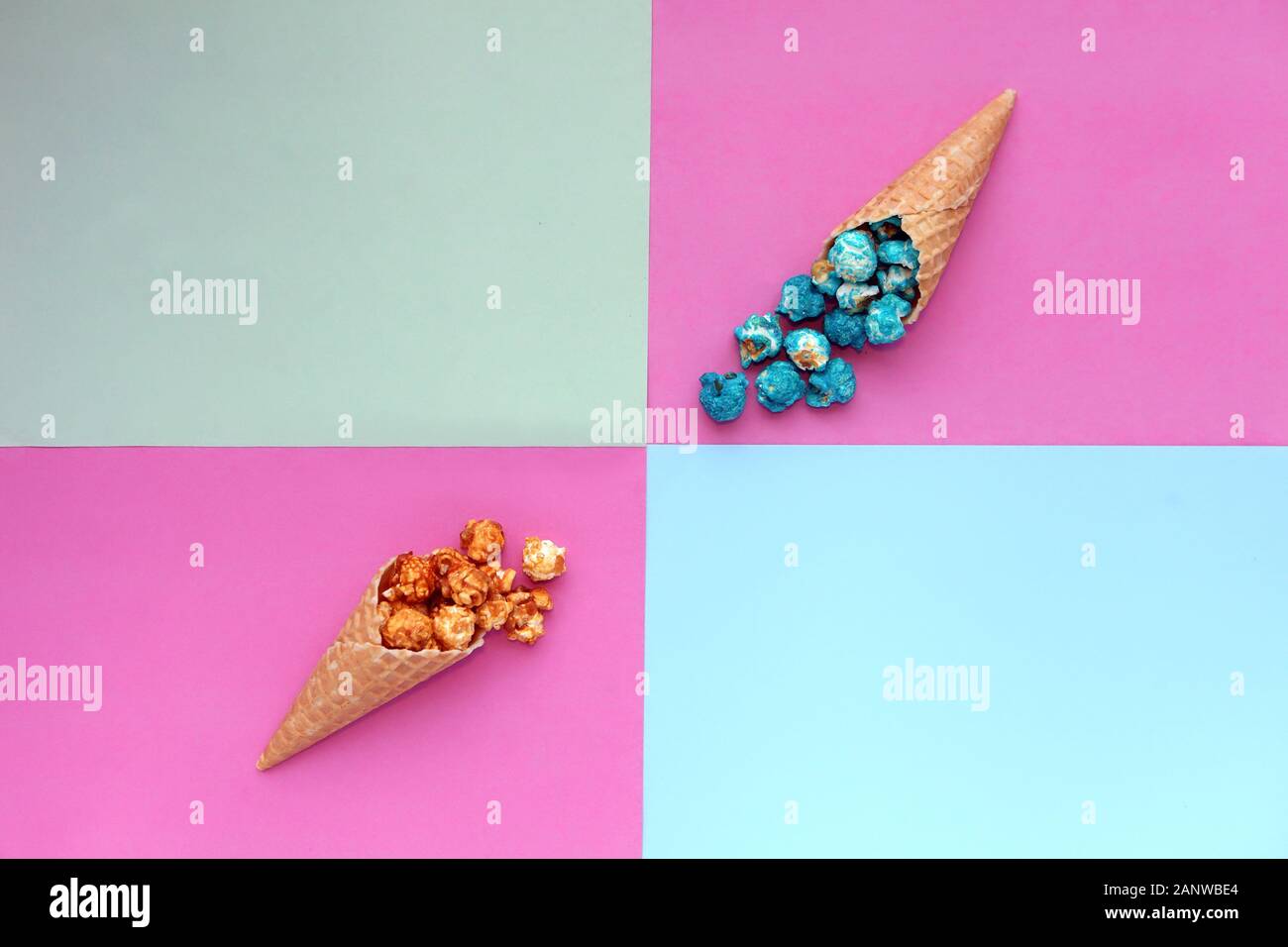 Popcorn spill out from waffle ice cream cone on pastel colorful