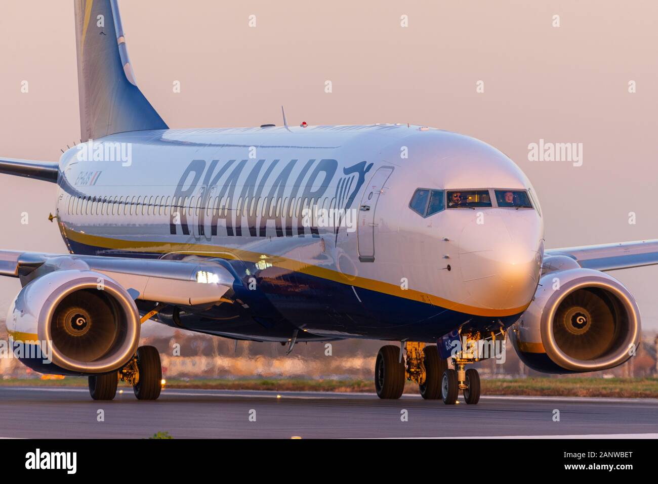Ryanair Boeing 737 airliner jet plane EI-GJS at London Southend Airport, Essex, UK. Late afternoon in winter. Dusk. Taxiing for departure. Orange glow Stock Photo