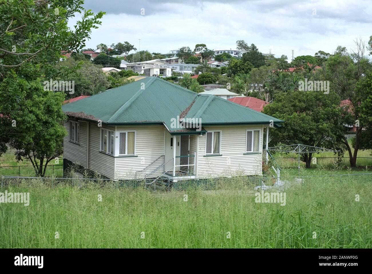 Green roof, weatherboard box on a block - Post War suburban houses in the Brisbane suburbs of Carina, Seven hills and Cannon Hill and their topography Stock Photo
