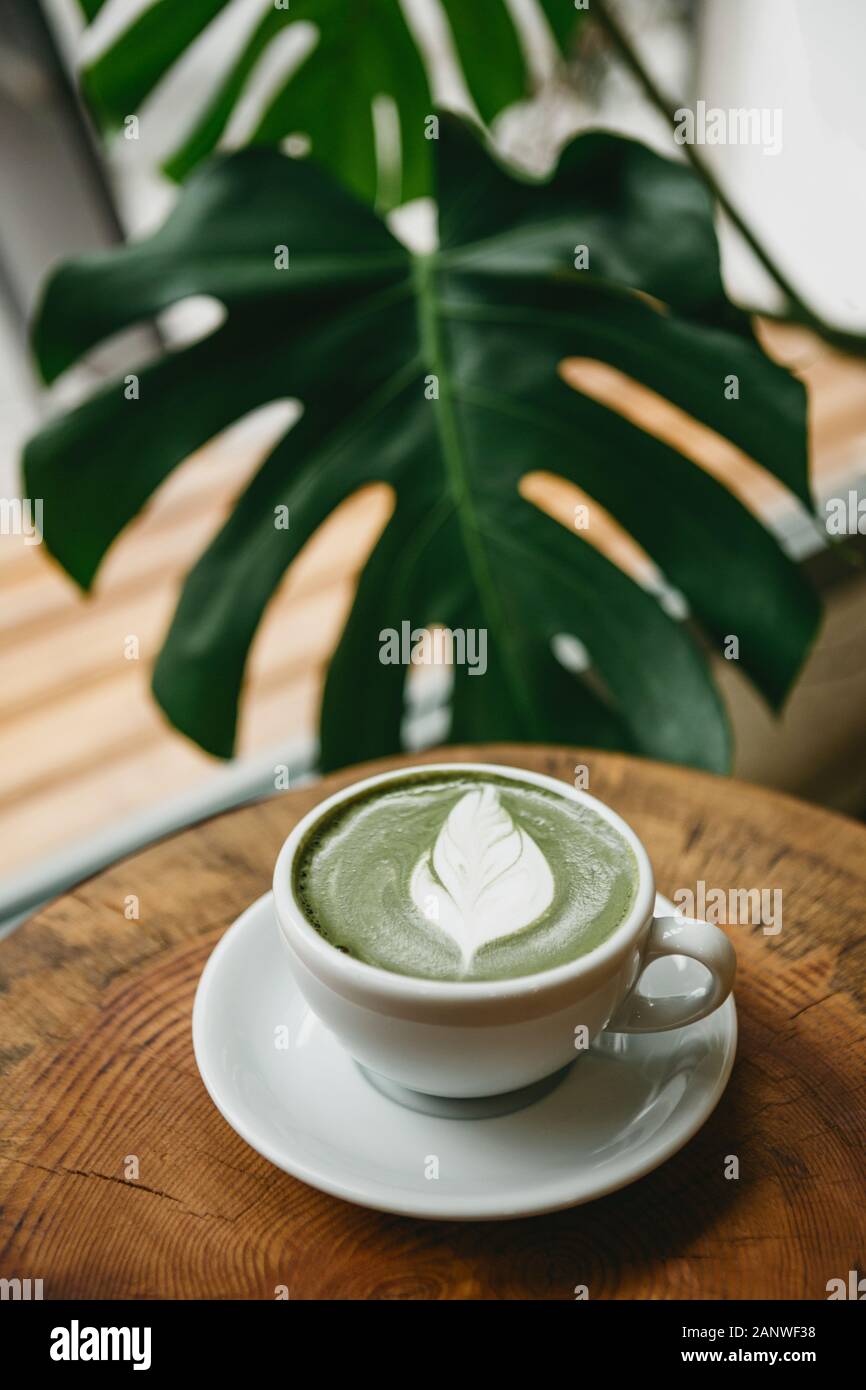Fresh aromatic green matcha latte tea on a wooden table. Natural antioxidant and dietary product. Stock Photo