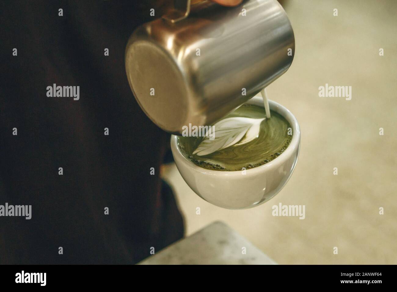 Barista prepares tasty and healthy matcha latte tea. Stock Photo
