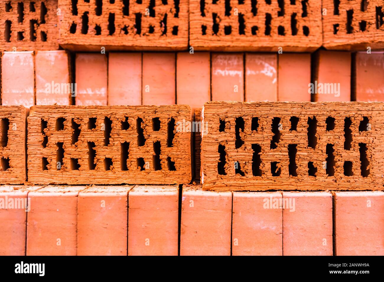 Pile of bricks texture wallpaper. Red bricks pile stacked for construction Stock Photo