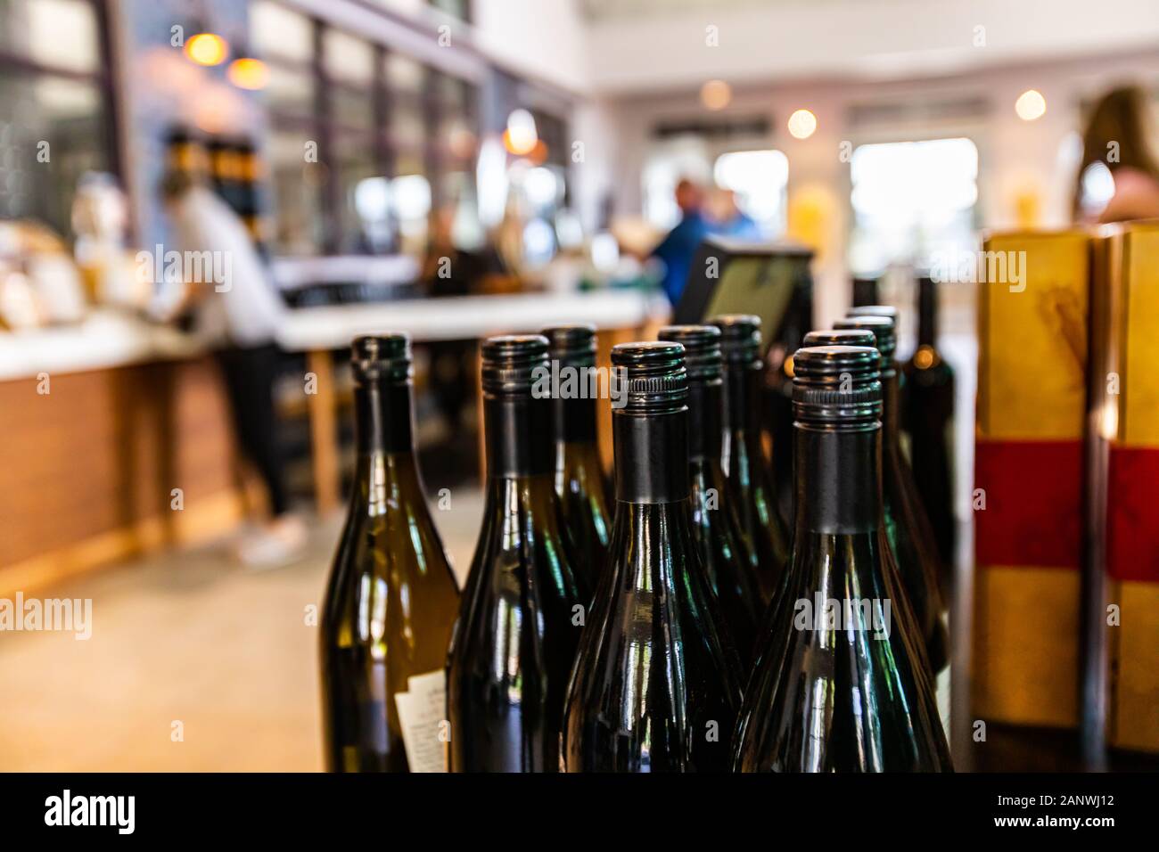 wine bottles, dark amber glass with black screw cap seal closeup