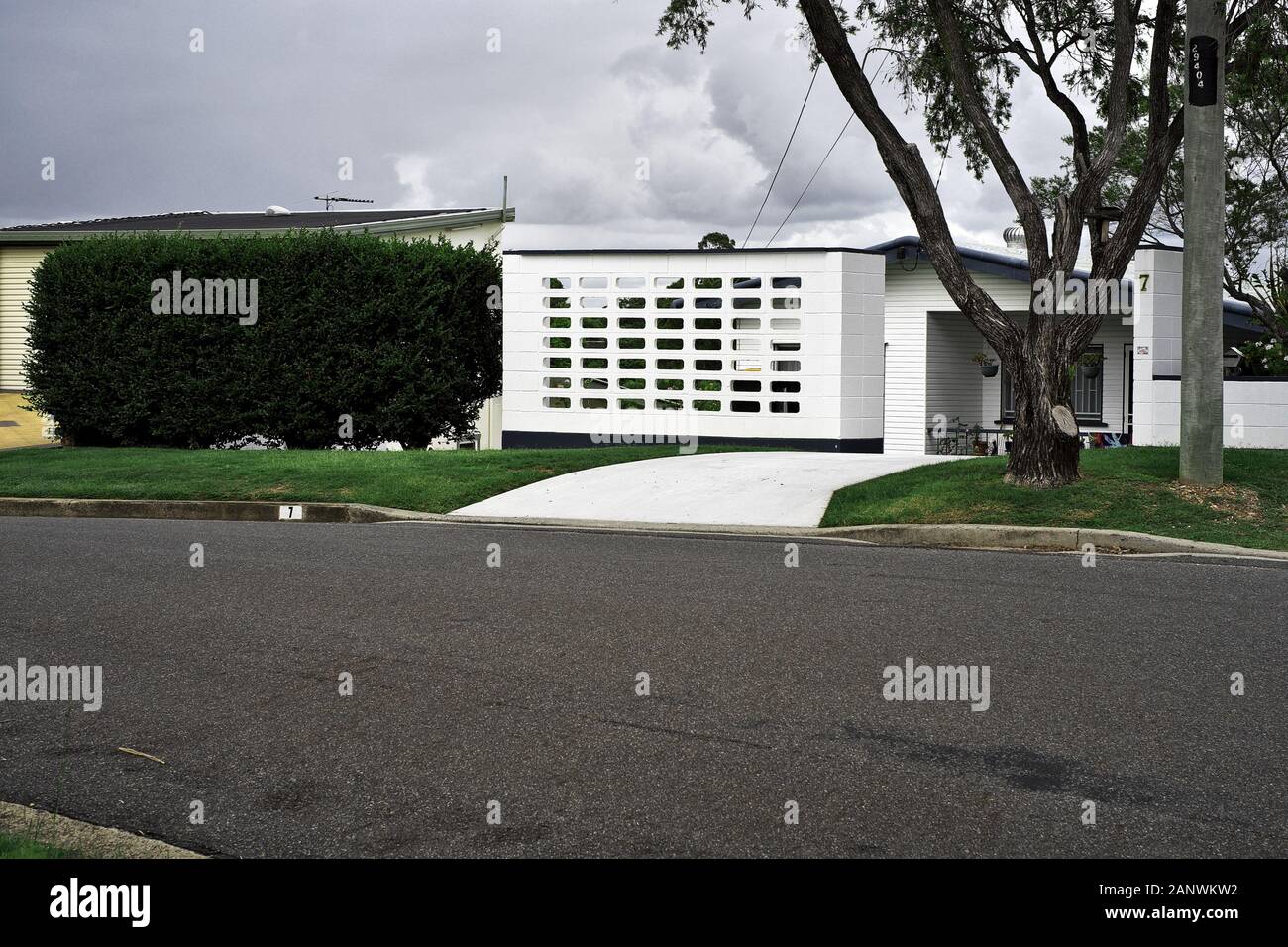 Breeze block wall and hedge for privacy. Architectural survey in the Brisbane suburbs of, Camp Hill, Seven Hills, Cannon Hill, their topography. Stock Photo