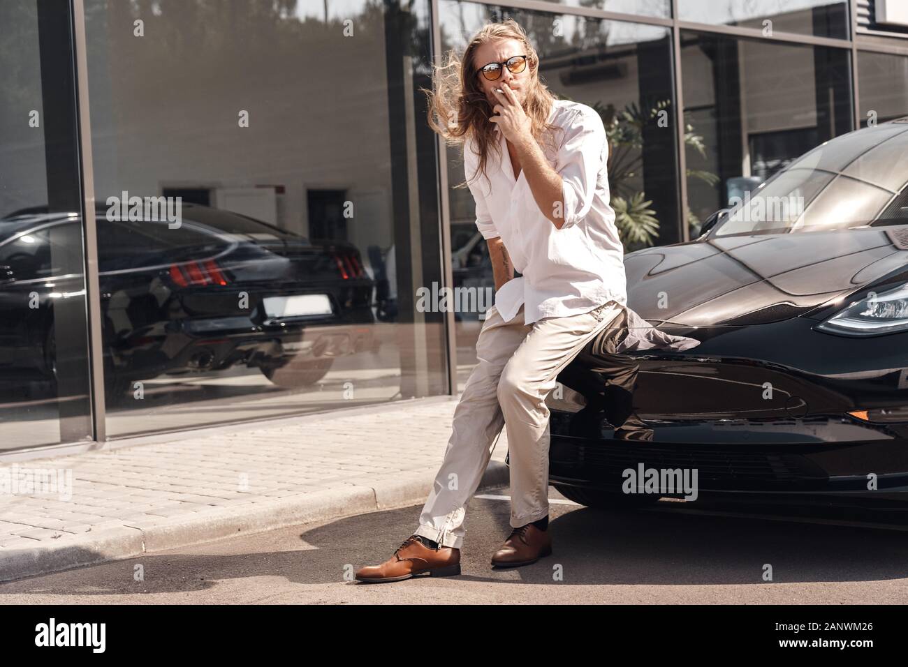 Mode of Transport. Man with long hair in sunglasses traveling by