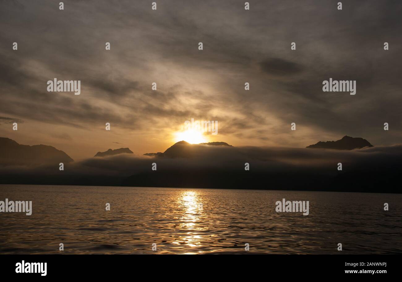 Sunrise over the mountains near the ocean in Alaska Stock Photo