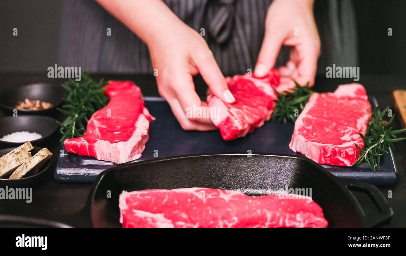 Raw New York strip steaks in cast iron frying pan Stock Photo Alamy