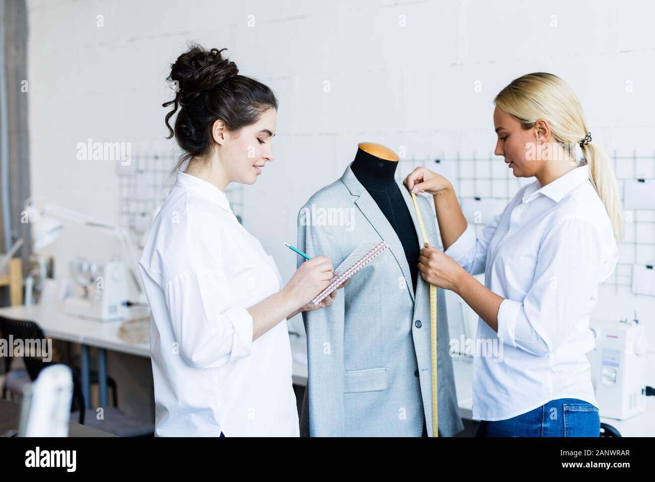 Girls sewing jacket together Stock Photo