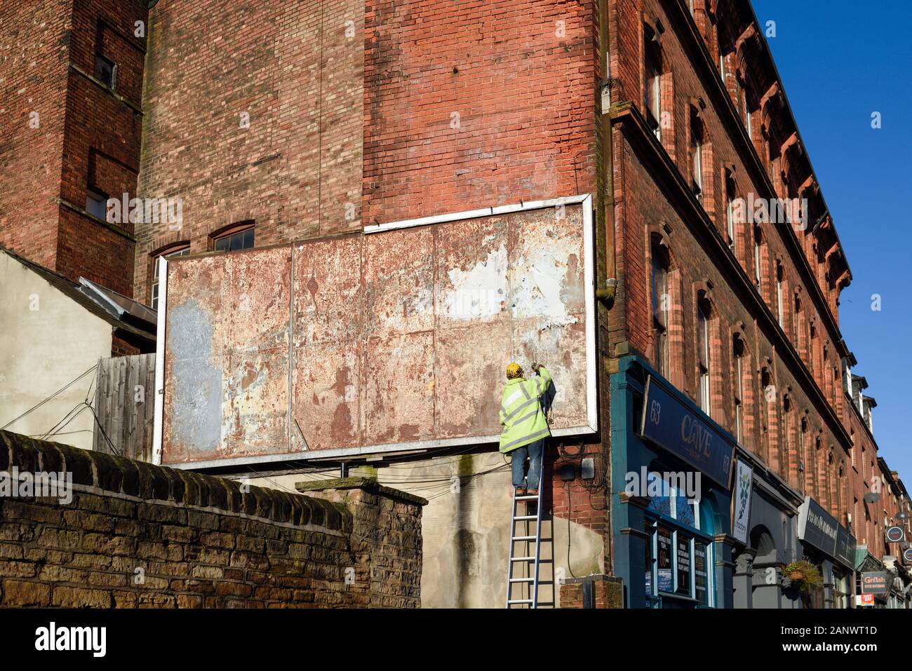 Man Working on a Billboard in Nottingham,UK. Stock Photo