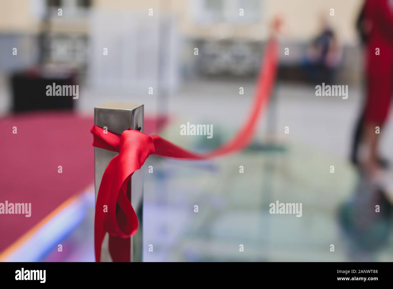 Process of cutting the red ribbon during the grand opening of the new