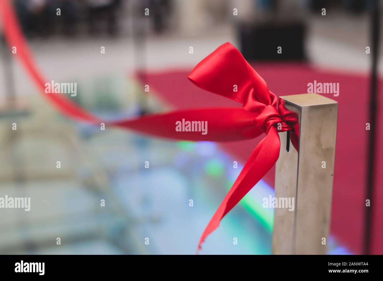 Process of cutting the red ribbon during the grand opening of the new