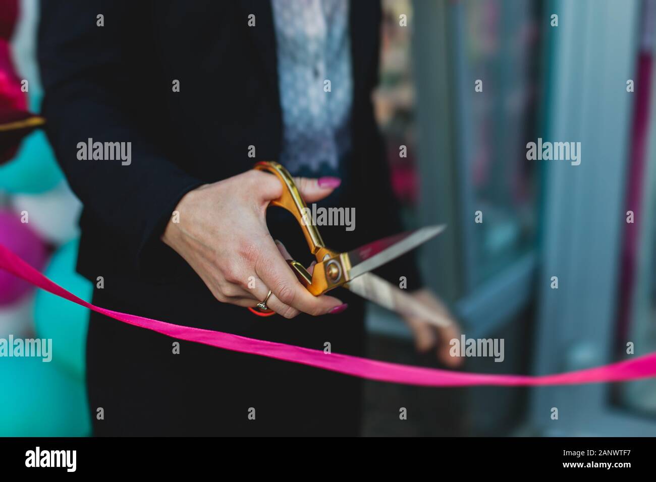 Process of cutting the red ribbon during the grand opening of the new