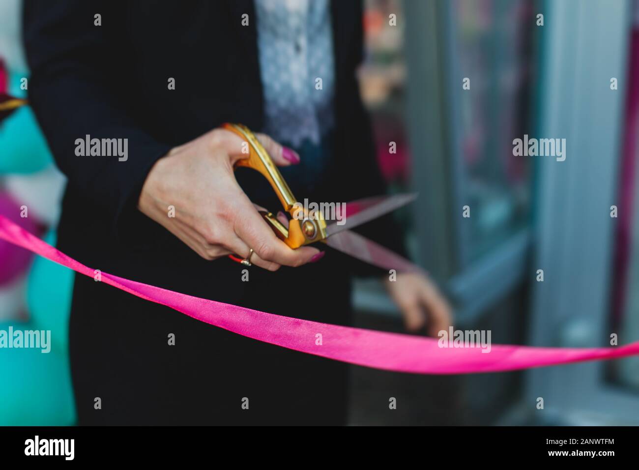 Process of cutting the red ribbon during the grand opening of the new