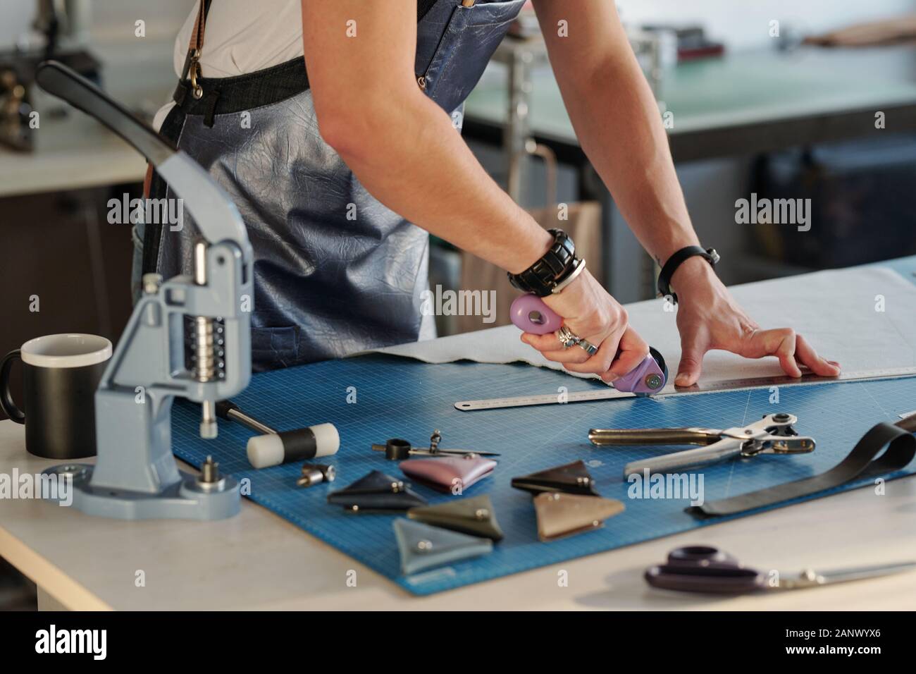 Using metal ruler to cut edge of leather Stock Photo - Alamy