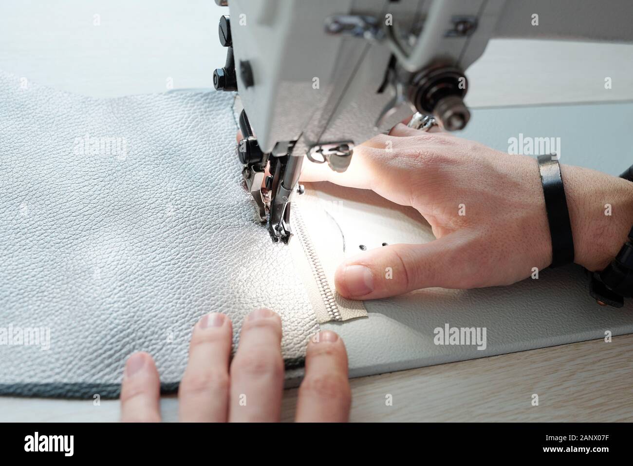 Sewing zipper to leather fabric Stock Photo