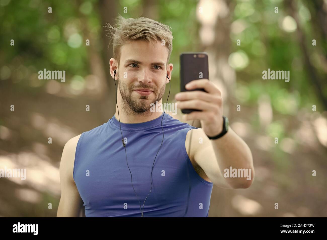 sport app on phone. digital sport. smart watch. athletic man in sportswear  make selfie. outdoor workout. Fitness app. Ui ux concept. gadget in modern  sport. muscular man in tracker. connection search Stock