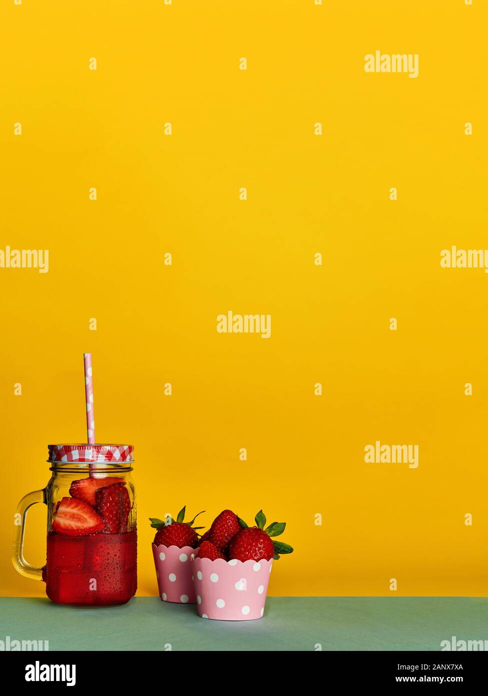 strawberry juice fresh, against a vivid yellow background Stock Photo