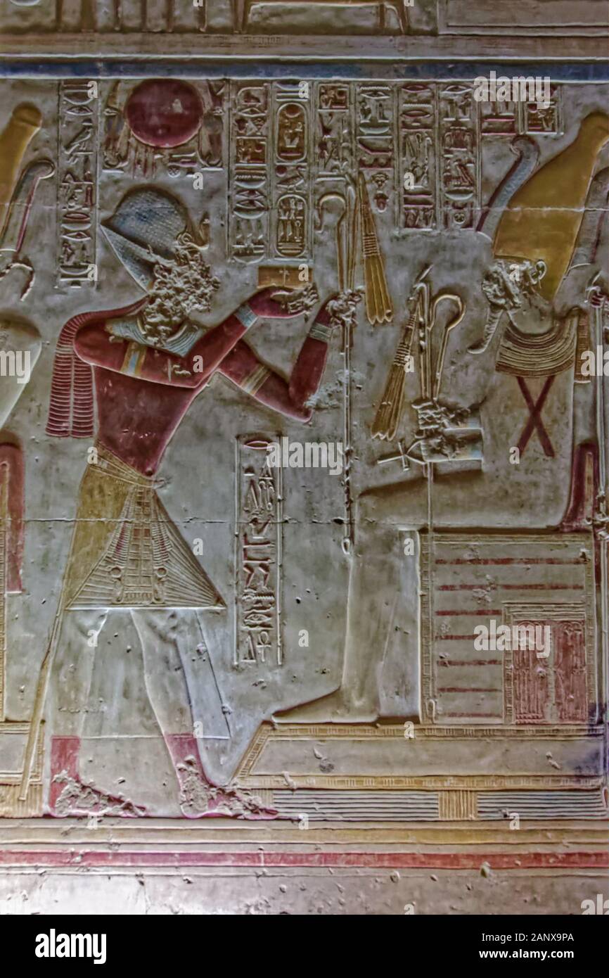 A frieze of Pharaoh Seti offering ornaments and insignia to Osiris from the South wall of the Chapel of Osiris at the Abydos Temple of King Seti I Stock Photo