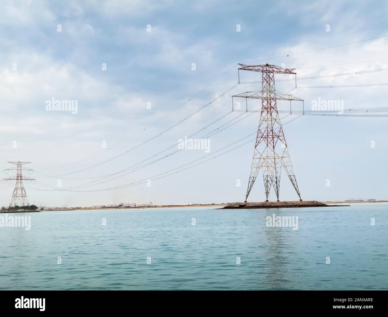 Red and white overhead electricity power lines and cables crossing