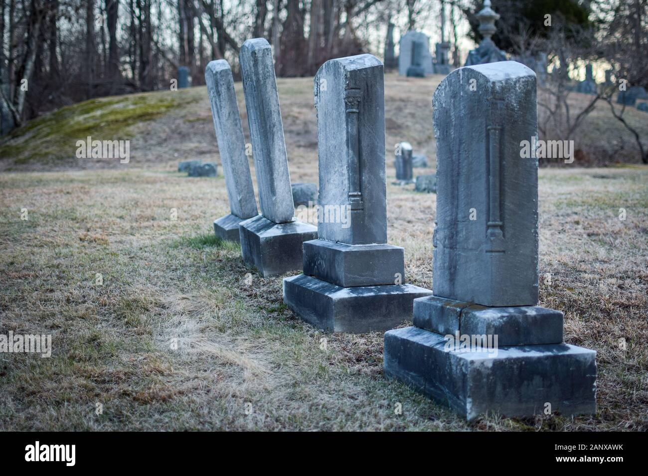 Headstones at an old dilapidated looking graveyard on a gray gloomy day