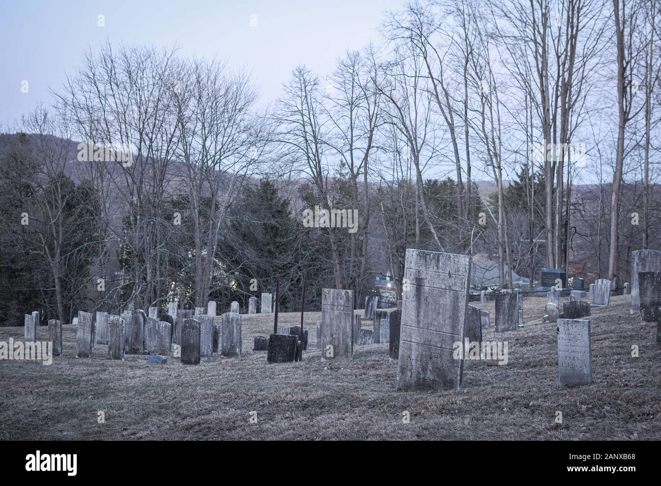 Headstones at an old dilapidated looking graveyard on a gray gloomy day