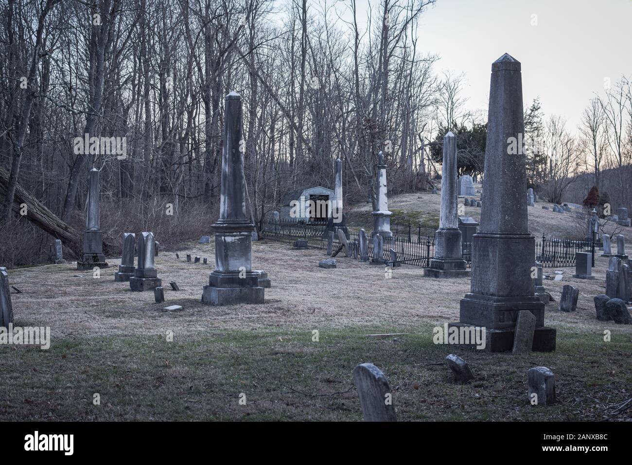 Headstones at an old dilapidated looking graveyard on a gray gloomy day