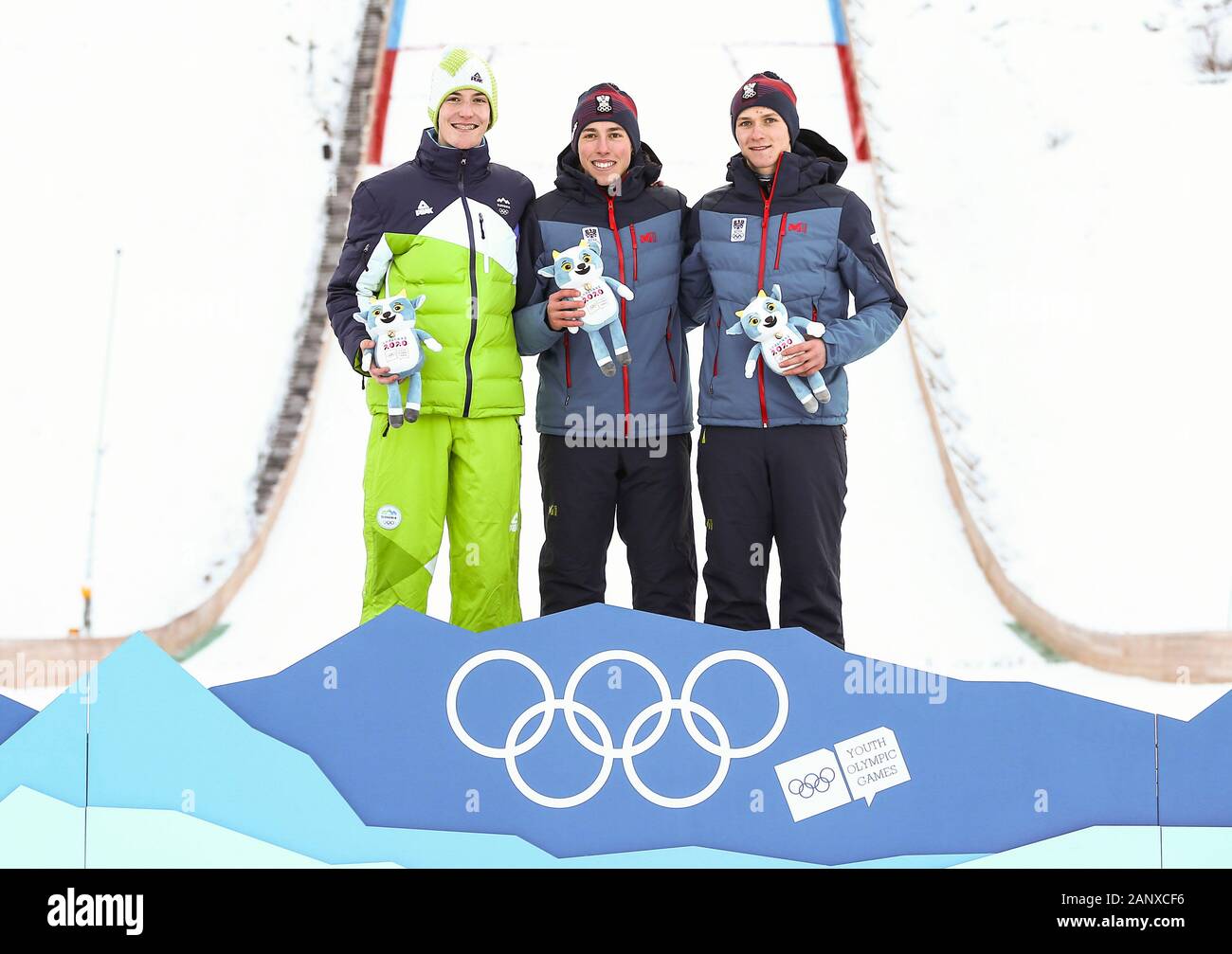 Les Rousses, France. 19th Jan, 2020. Gold medalist Marco Woergoetter (C) of Austria, silver medelist Mark Hafnar (L) of Slovenia and bronze medalist David Haagen of Austria pose for photos during the mascot ceremony for men's individual ski jumping event at 3rd Winter Youth Olympic Games at Les Tuffes Nordic Centre in Les Rousses, France, Jan. 19, 2020. Credit: Shan Yuqi/Xinhua/Alamy Live News Stock Photo